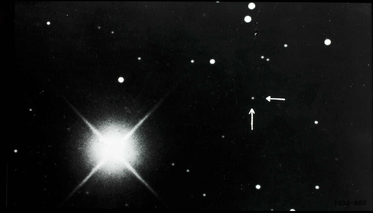 This Lowell Observatory photograph announcing the discovery shows Pluto marked with arrows. Credit © SCM / Science & Society Picture Library