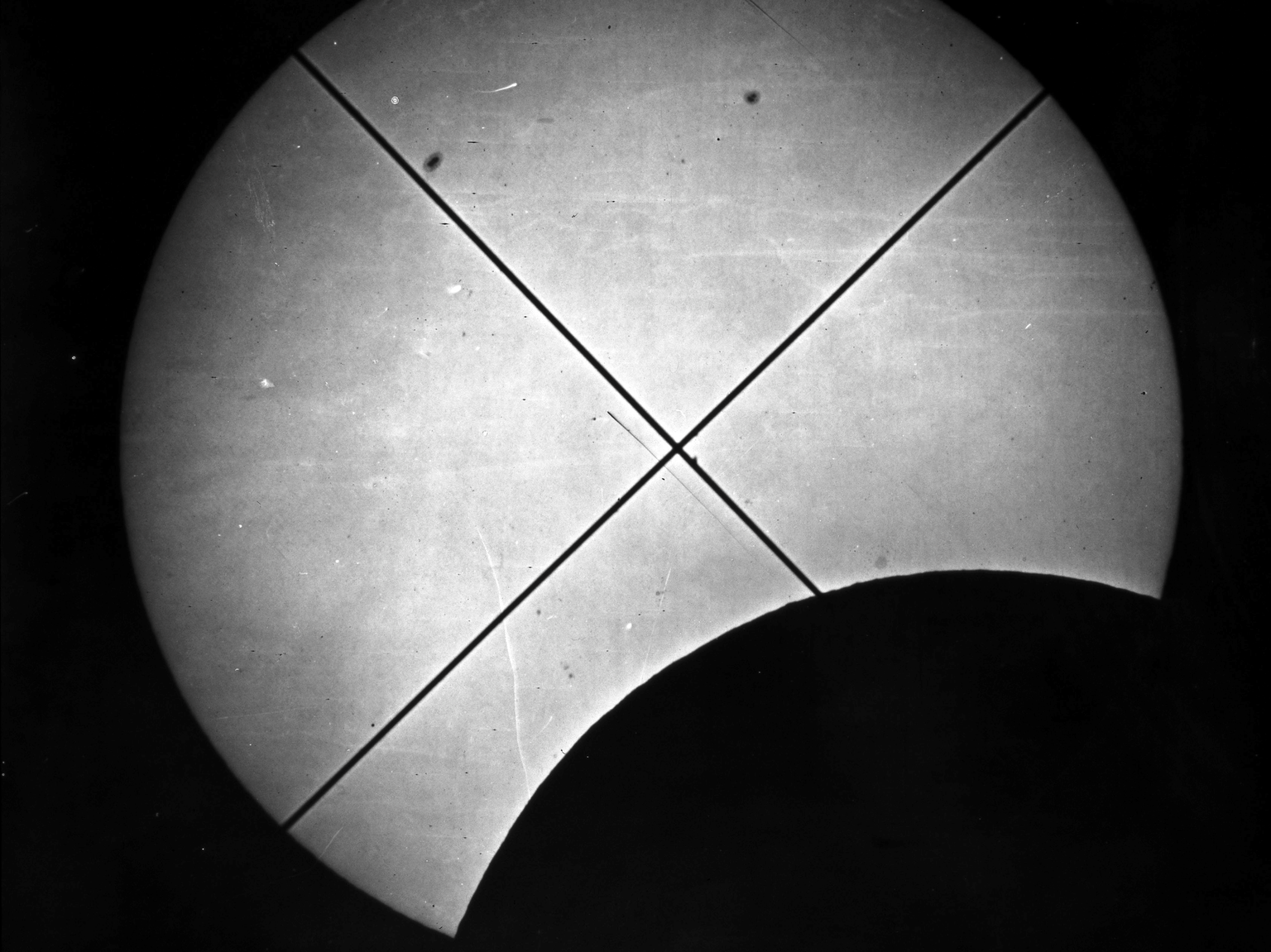 An expedition photograph of the eclipse before totality (Science Museum).