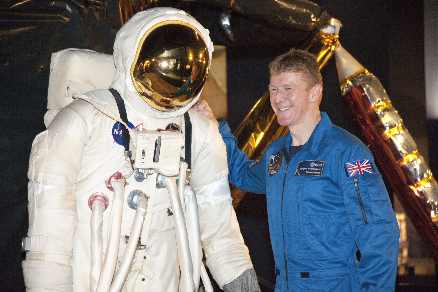 Tim Peake pictured with a space suit from the Exploring Space gallery. Image: Science Museum