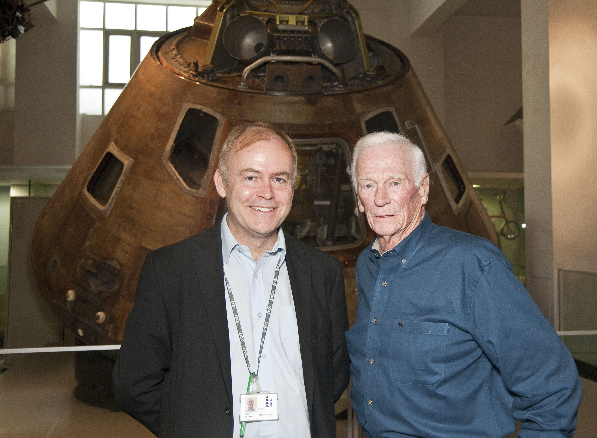 Gene Cernan with Curator Doug Millard (l) in front of Apollo 10. 