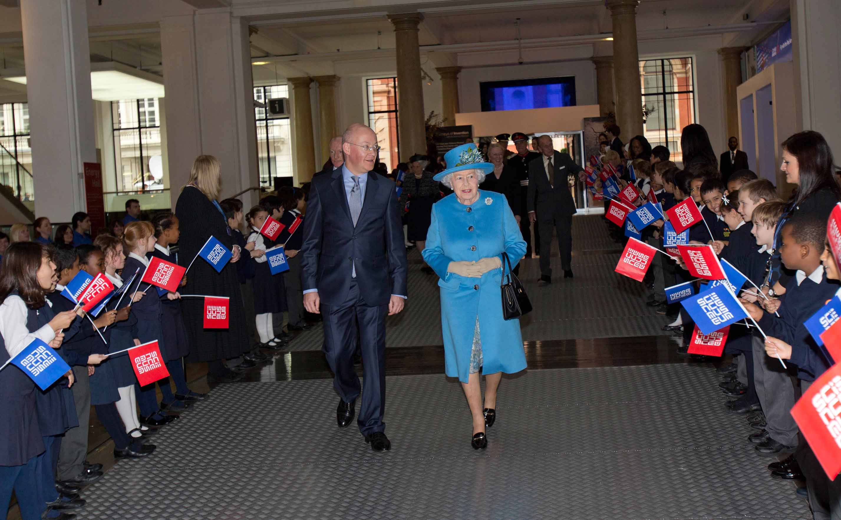 The Queen is greeted by school children as she enters the Museum with Science Museum Director Ian Blatchford. Image credit: Tim Anderson
