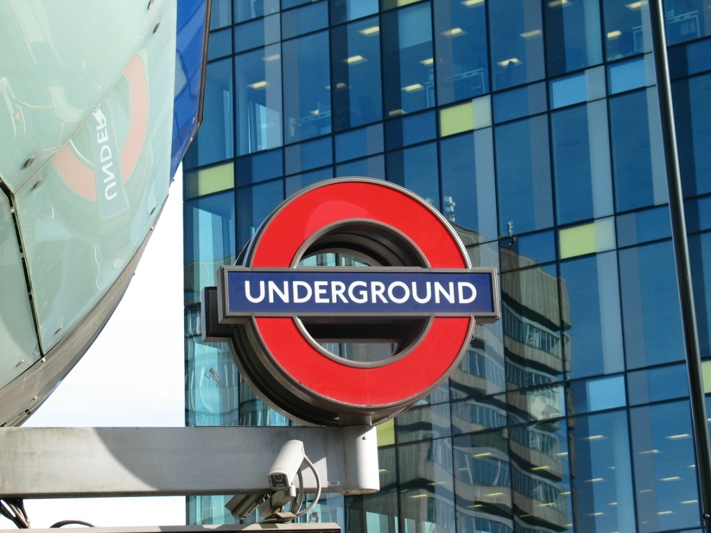 London Underground sign and surveillance camera.