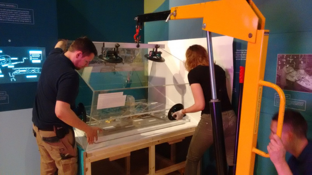 Museum staff carefully move the display case into place. Credit: Science Museum