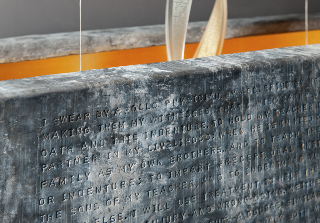 A lead casket embossed with the ancient Greek Hippocratic Oath.