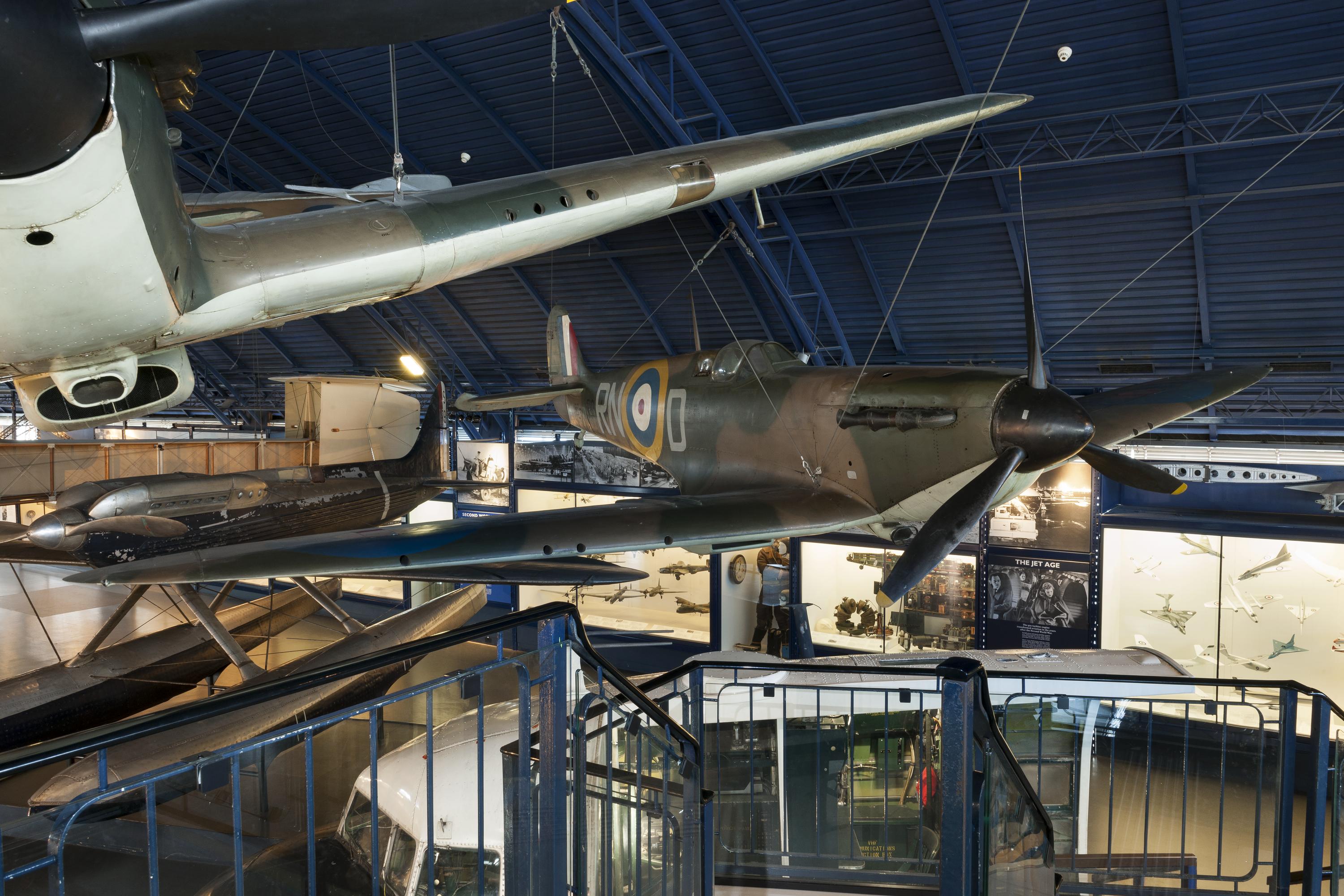 Vickers-Supermarine Mk1 Spitfire, No. 9444, (centre) with part of Hawker Hurricane pictured on display in the Flight Gallery