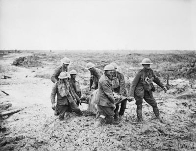 A stretcher bearer team in mud up to their knees near Boesinghe at the Battle of Pilckem Ridge (Ypres, 1st August 1917). ©IWM (Q5935)