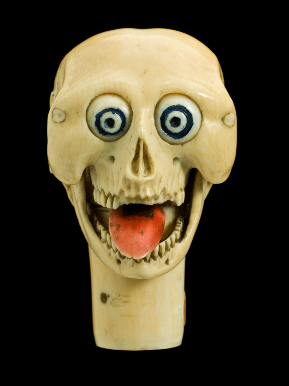 Ivory model of a skull, stylized, with moving eyes, tongue and mandible.