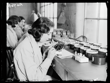 Women using luminous paint at the Ingersoll Watch and Clock Factory. Credit: Daily Herald Archive 