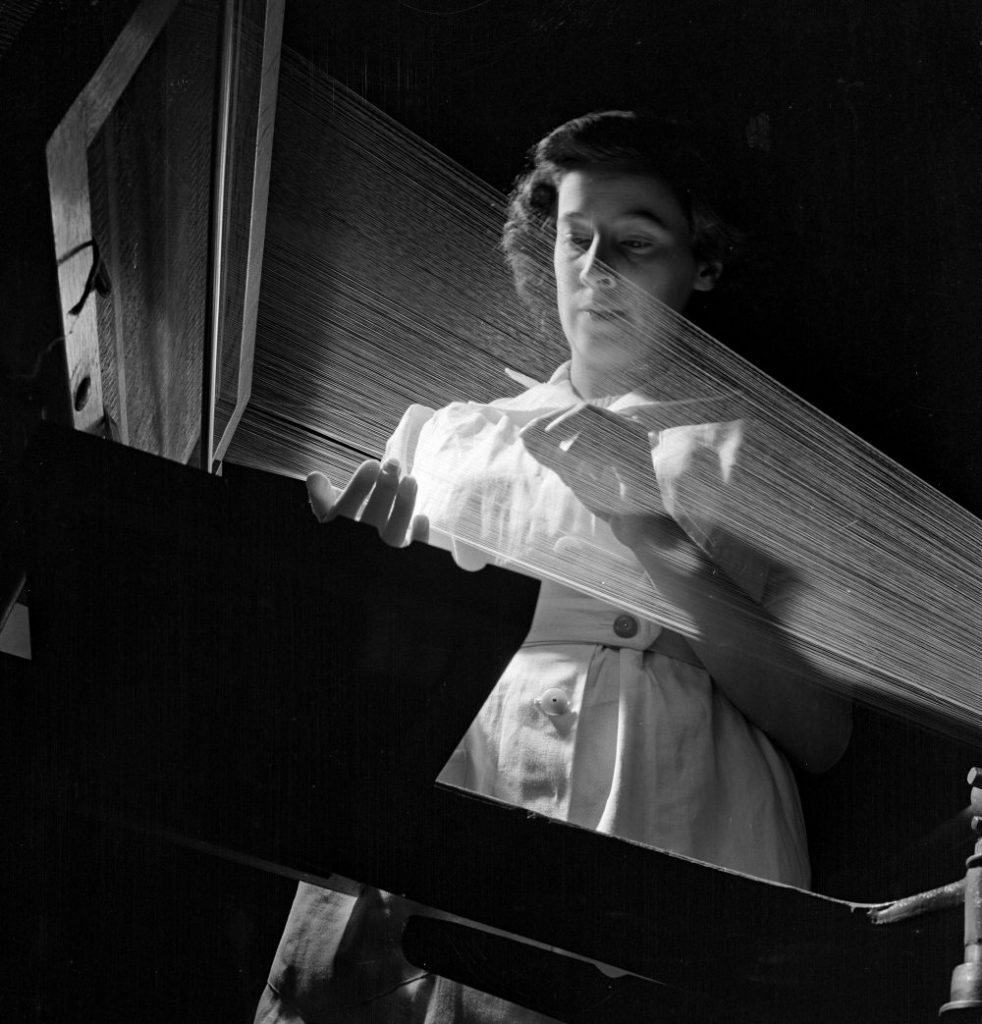 Female worker with nylon warp straightens twisted ends on the loom. © Walter Nurnberg/National Museum of Science & Media