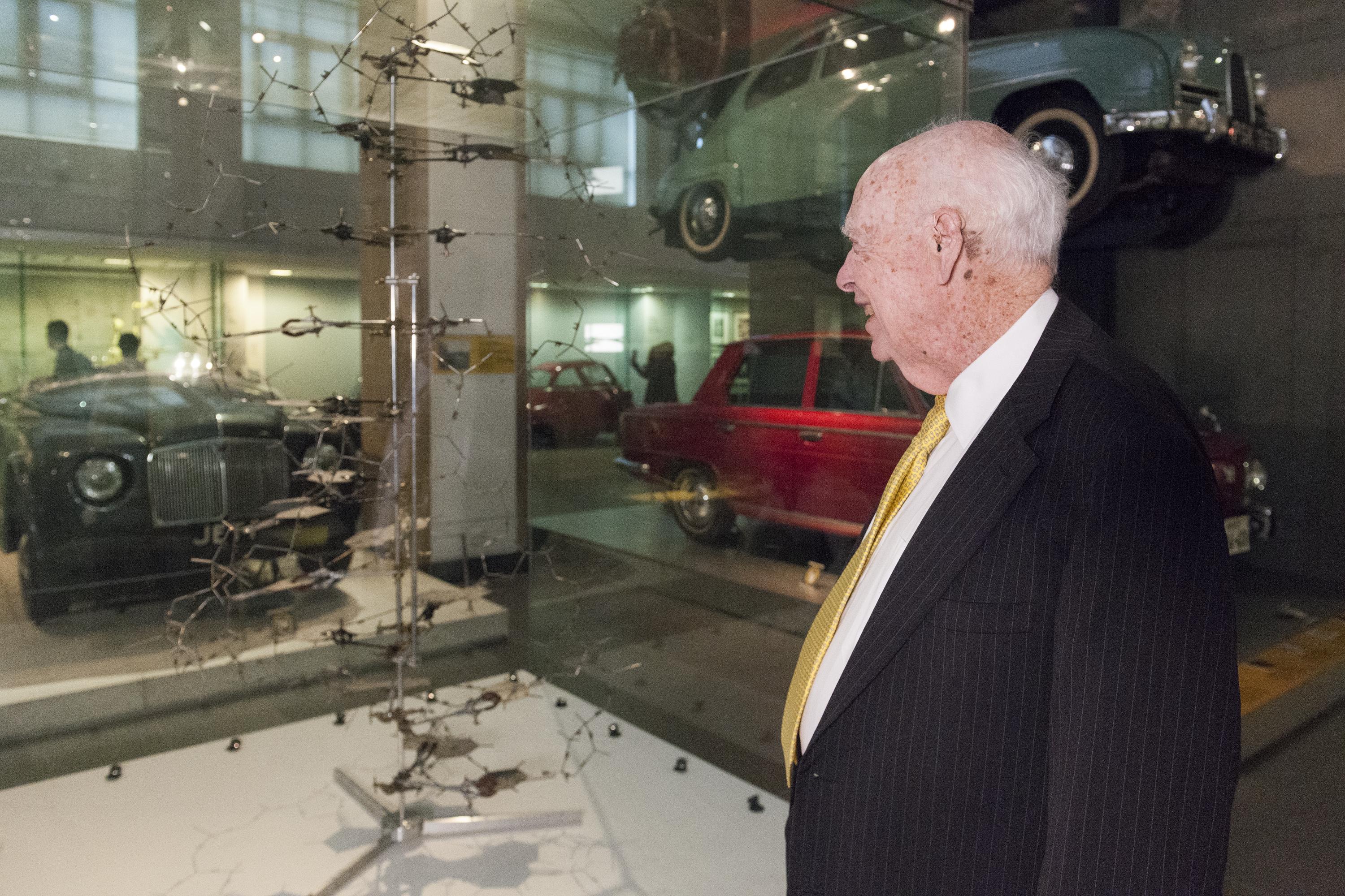 Portrait of James Watson, American molecular biologist, geneticist and zoologist, best known as one of the co-discoverers of the structure of DNA in 1953 with Francis Crick and Rosalind Franklin. Pictured in the Museums Making the Modern World Gallery with E1999.597.1 Replica of the Crick and Watson DNA model, by Science Museum, Workshops, South Kensington, London, England, 1996