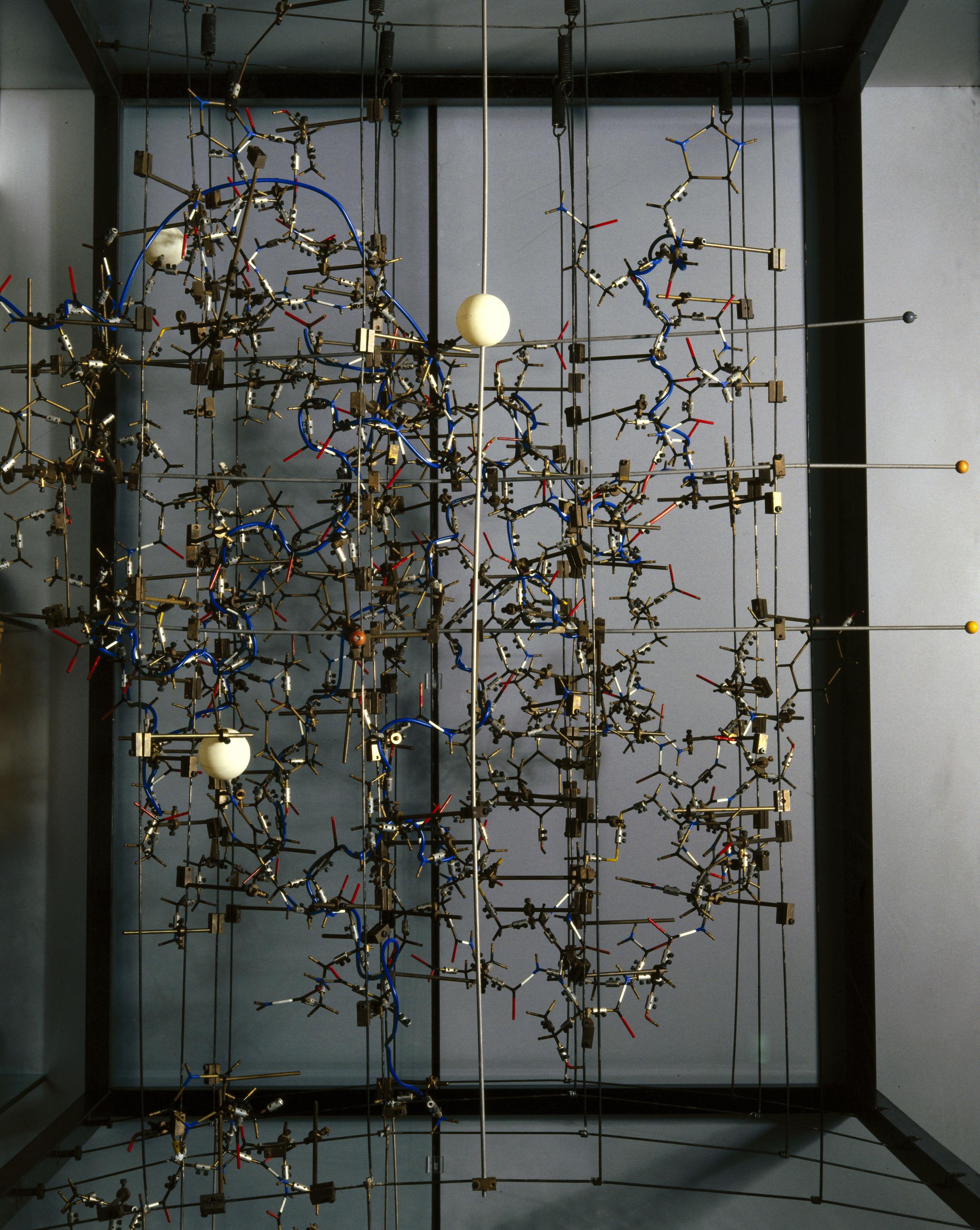 Model, one of two, made by Dorothy M. Crowfoot Hodgkin c.1967, to show the structure of 2 zinc pig insulin crystals at a resolution of 2.8A. Photographed as on display in gallery. Grey background.