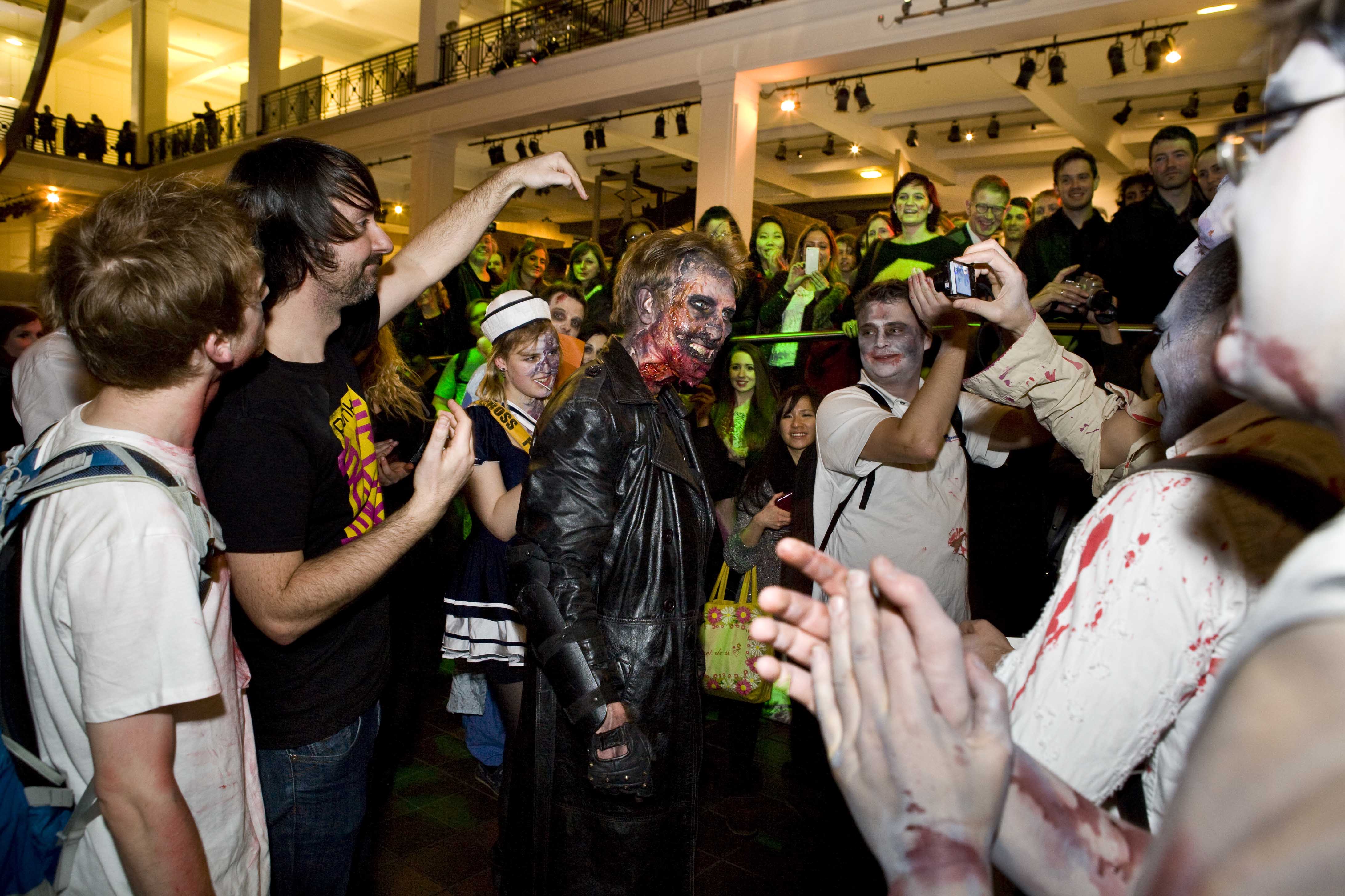 Visitors and actors dressed as Zombies at Zombie Lates, January 2013