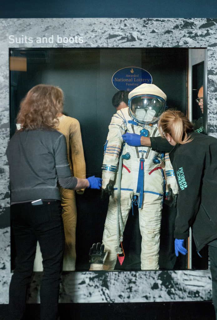 Geri Spencer, conservation assistant supervisor, and, conservation assistants, installing 2006-40/1 Helen Sharman's spacesuit which is being re-displayed in the Exploring Space gallery