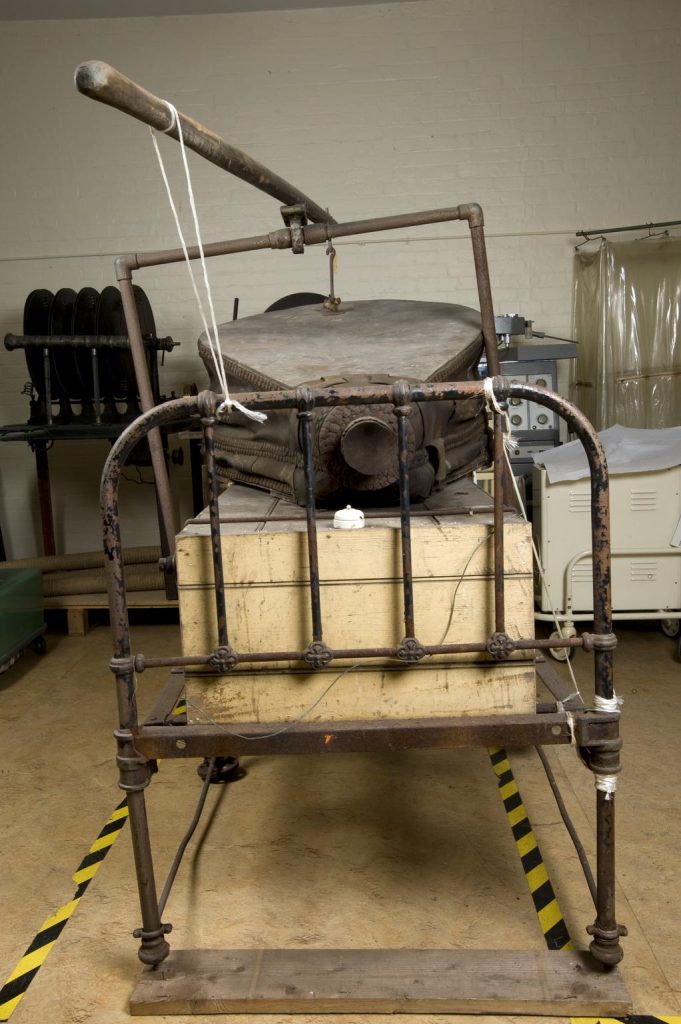 The patient was encased in the wooden box up to their neck. The air pressure inside the box was alternated by operating the giant set of leather bellows. This caused the lungs to inflate and deflate so the person could breathe.