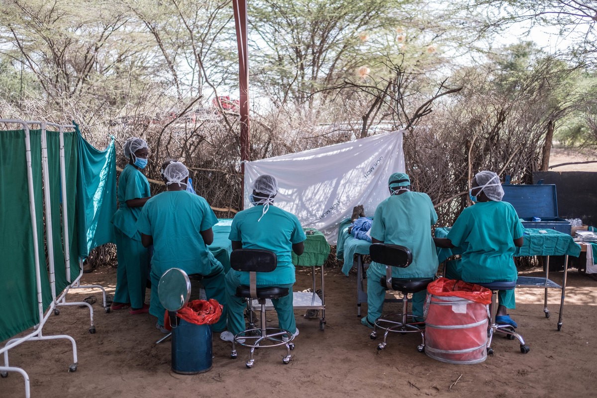 A makeshift operating theatre with doctors treating patients