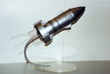Scale model of Vostok spacecraft imitating the spacecraft in flight with with wires at the bottom to represent exhaust flames.