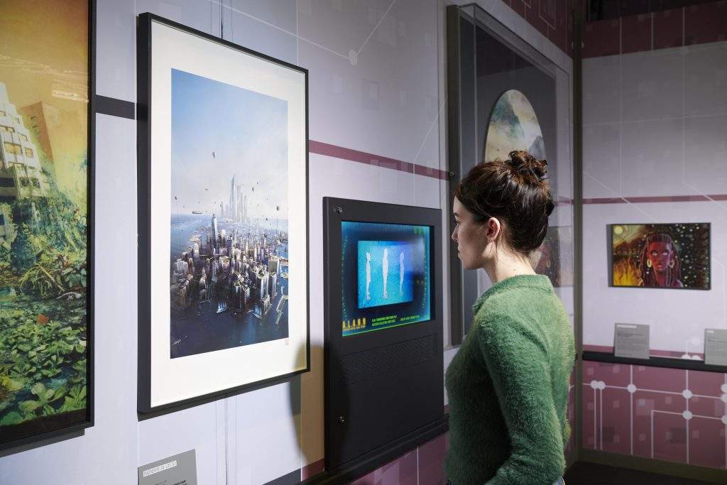 A visitor looks at NY2140 by Stephan Martinère (2017) in the Visualisation Deck in Science Fiction Voyage to the Edge of Imagination