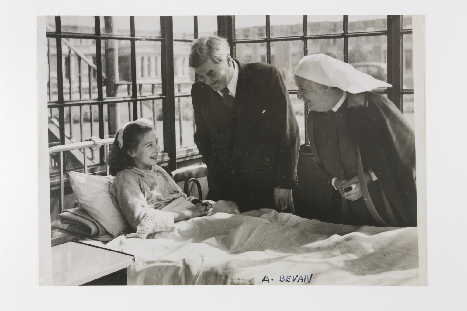 Daily Herald photograph showing Aneurin Bevan visiting Silvia Beckenham, the first NHS patient.