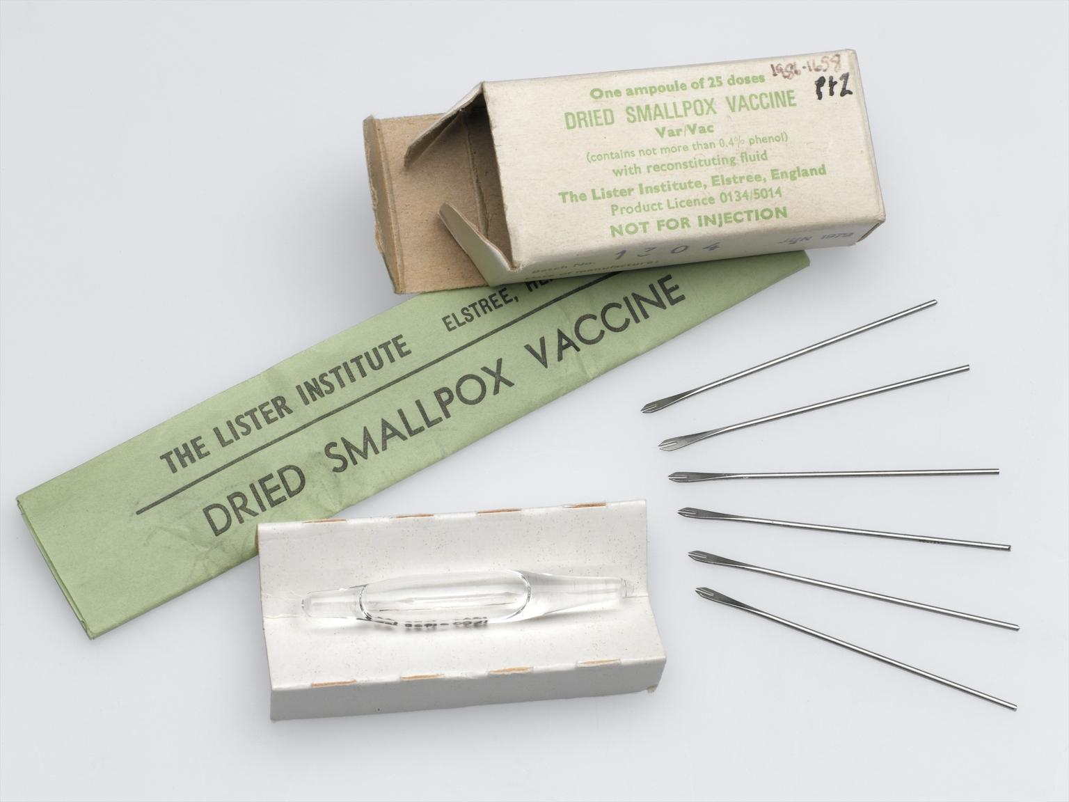 Packet of dried smallpox vaccine (1986-1658) with six bifurcated needles for smallpox vaccination (1979-61).