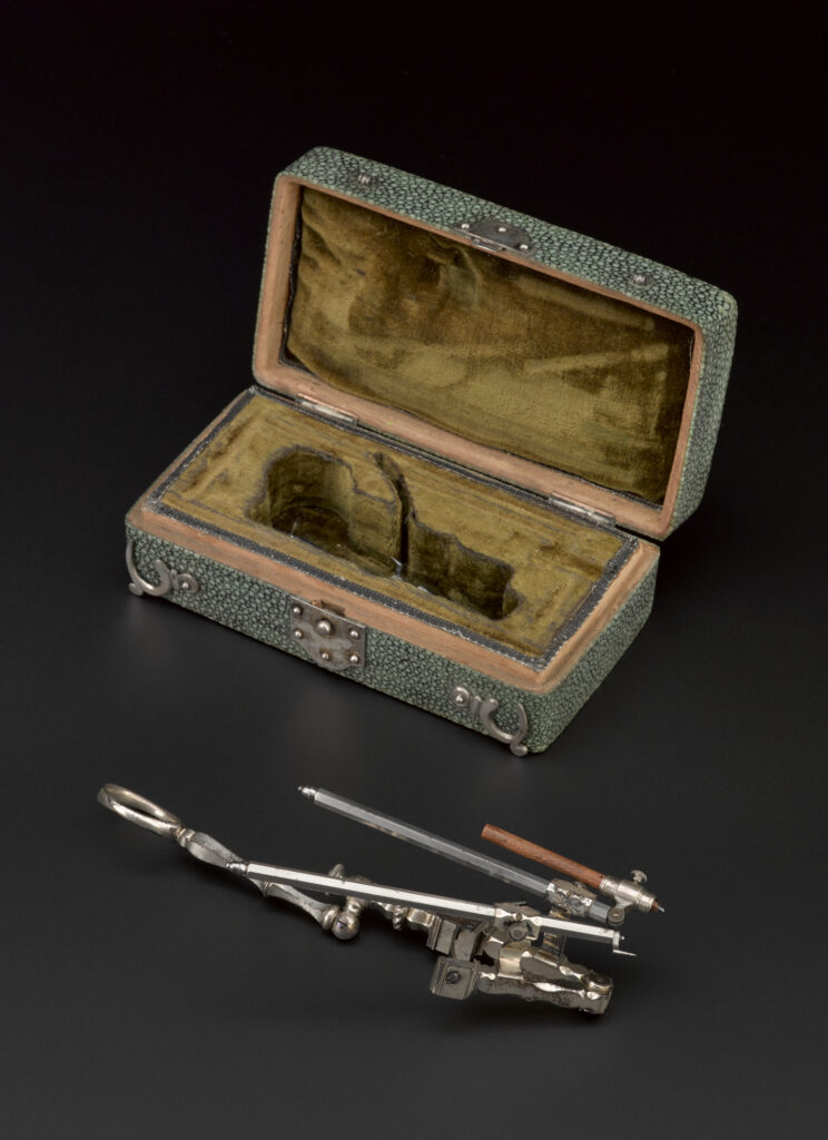 A left-handed Volute compass and box, from the Science Museum Group Collection. 