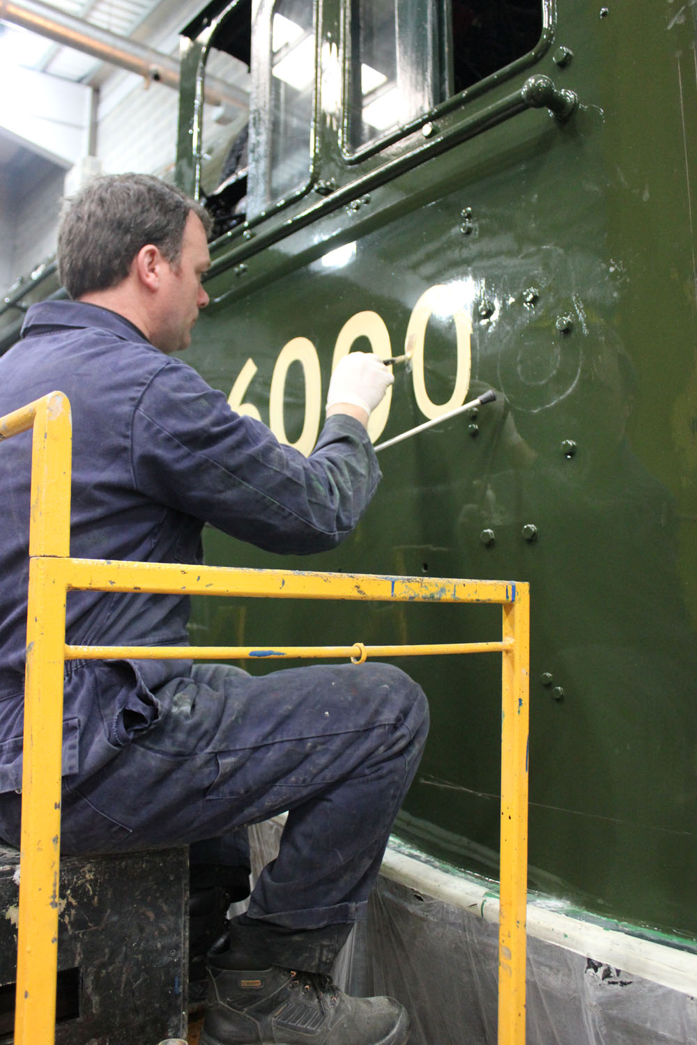 Finishing touches are made to Dwight D Eisenhower, during its cosmetic restoration. Credit: NRM