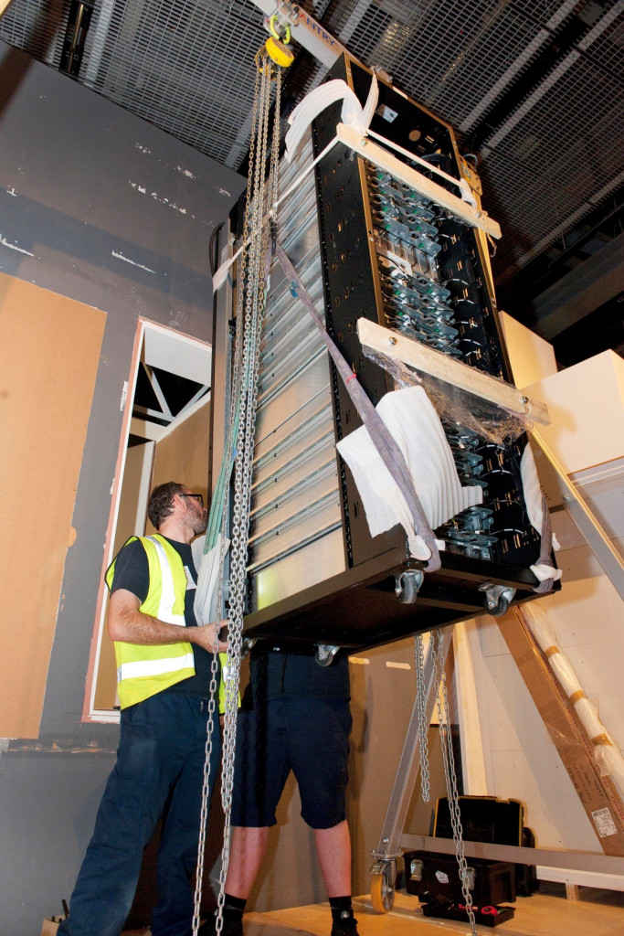 The crane lifts the cushioned server into place.