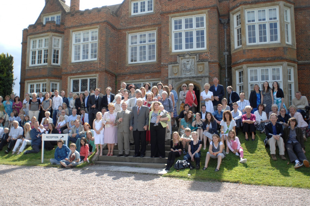 Robert Edwards (centre) standing next to Louise Brown (right) at the Bourne Hall IVF clinic, alongside many of the families helped by IVF. Image: Courtesy of Jenny Joy. 