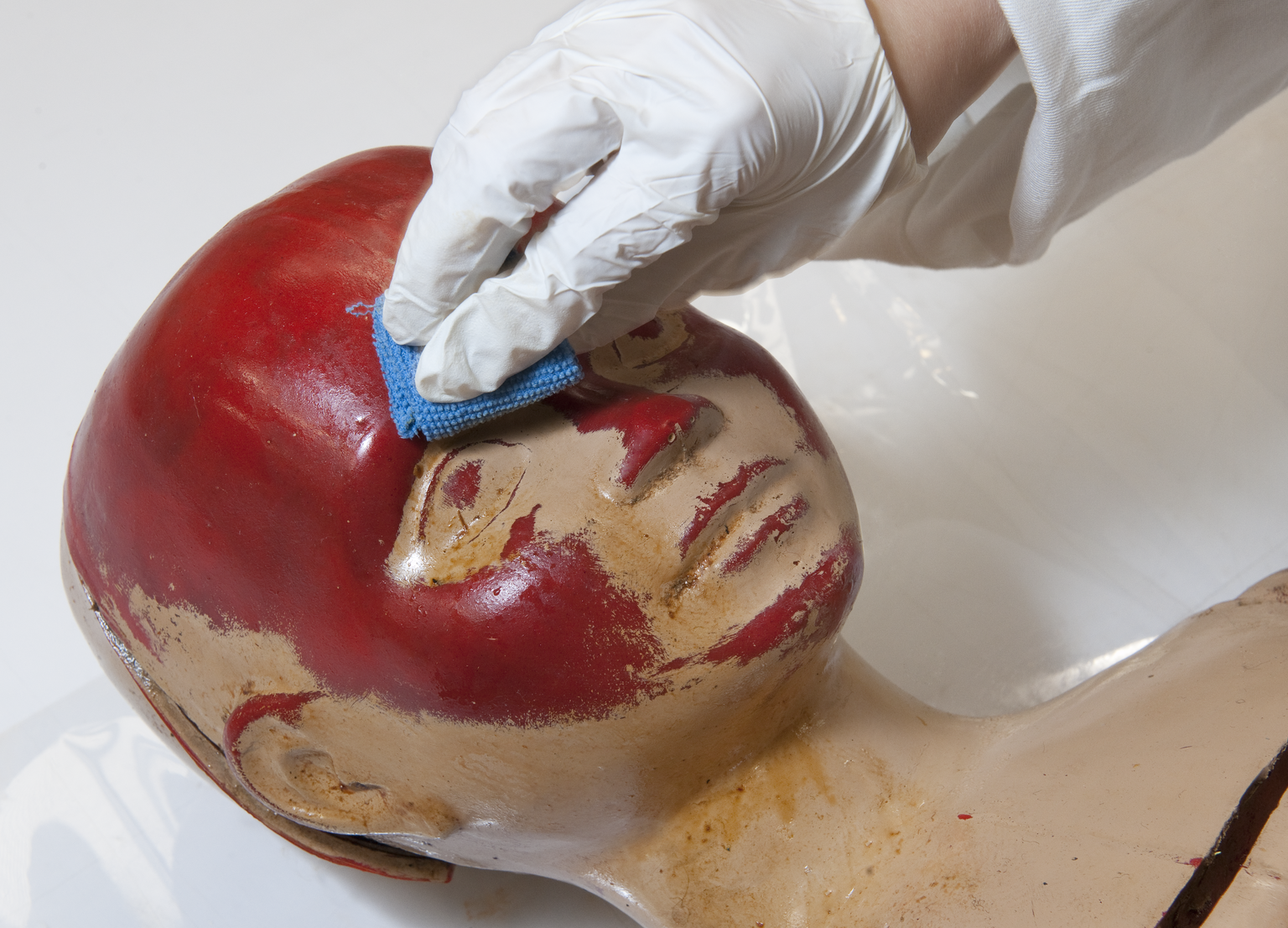 Science Museum Conservation Intern working on a crash test dummy from the Museum collection.