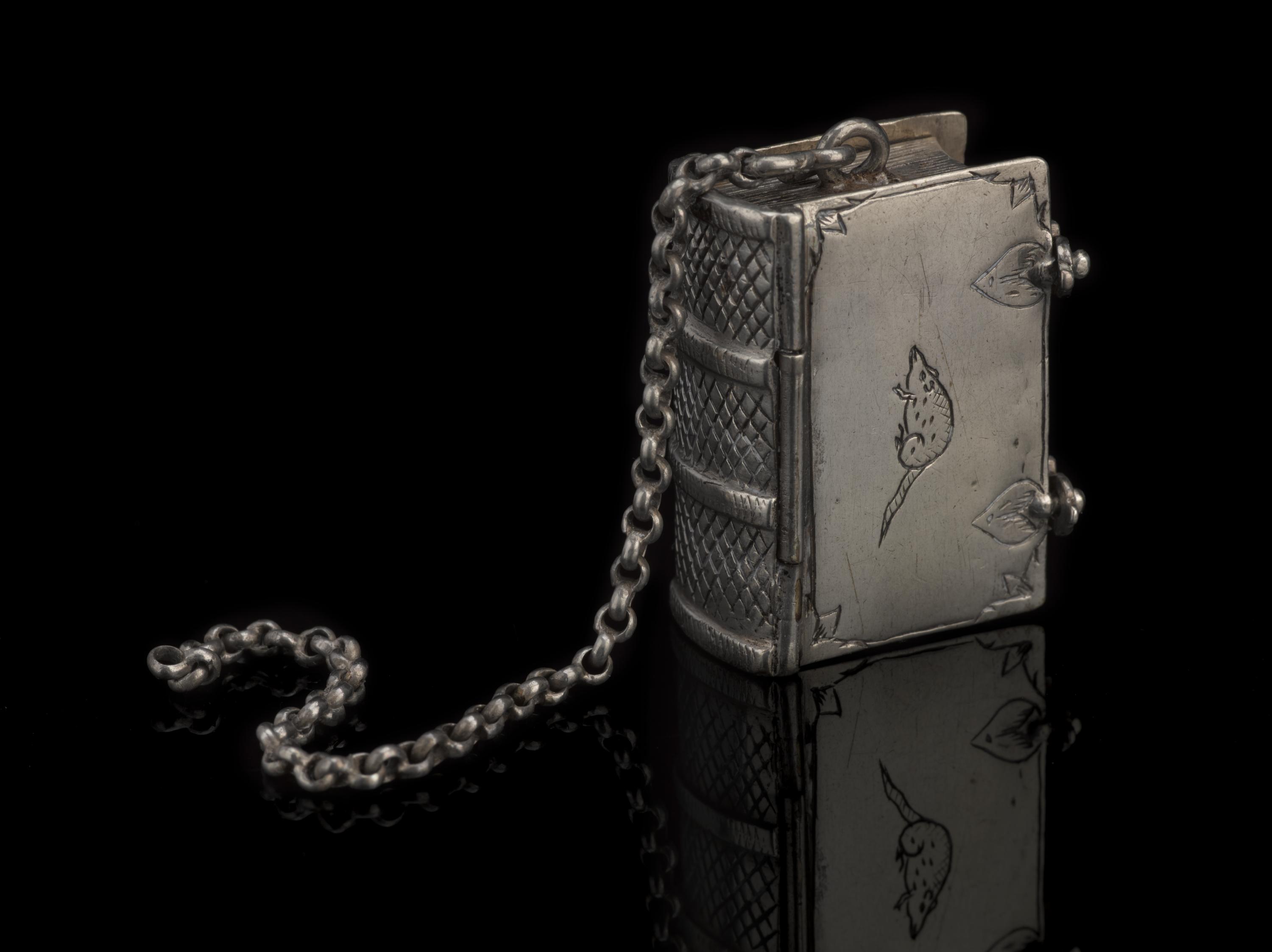 Silver pomander, in the form of a book, containing 6 compartments, with a rat engraved on the side, and chain for suspension, c. 1601-1700 