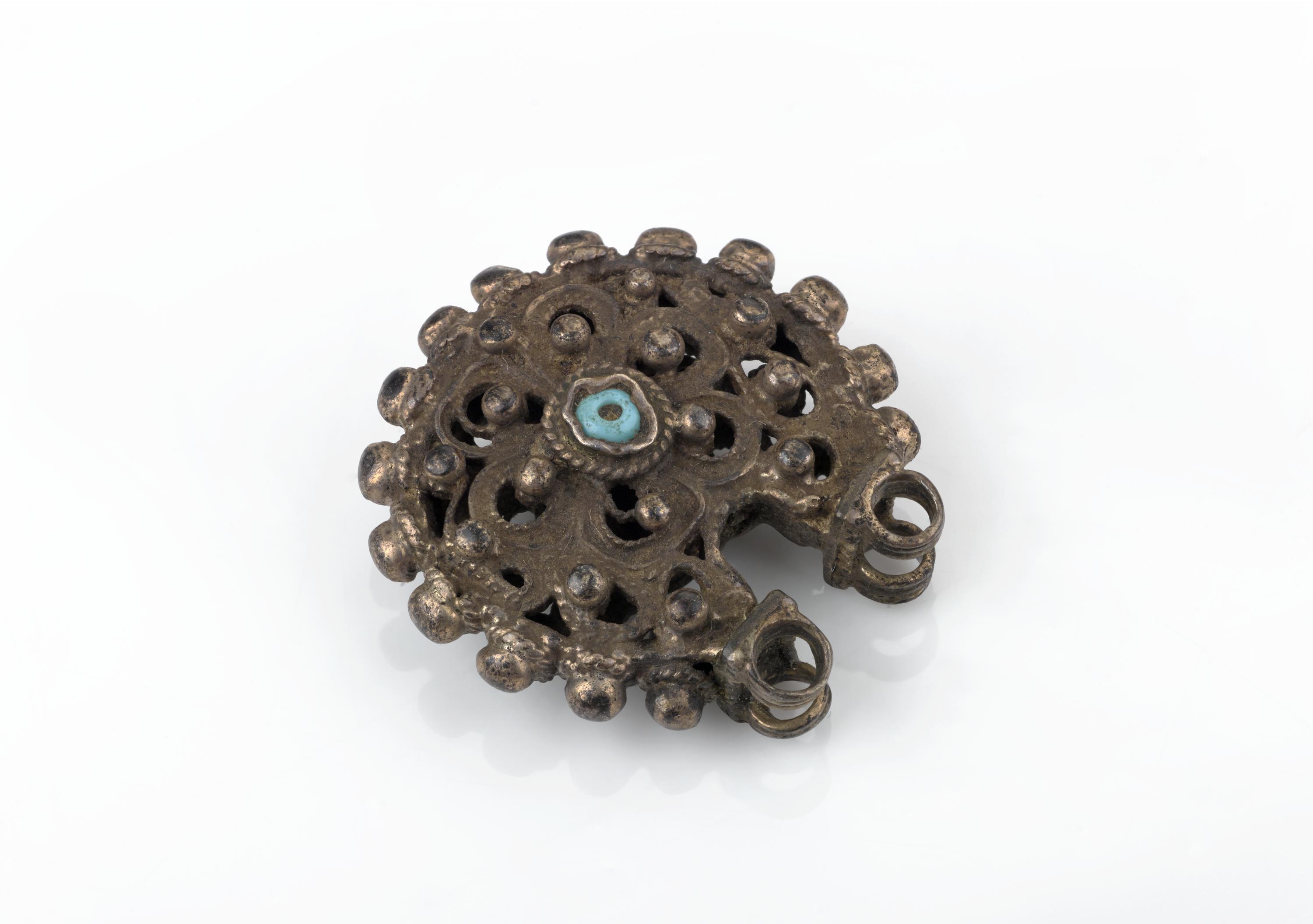 Circular filigree earring with floral design and decorative blue beads, amuletic, Palestinian, 1880-1930