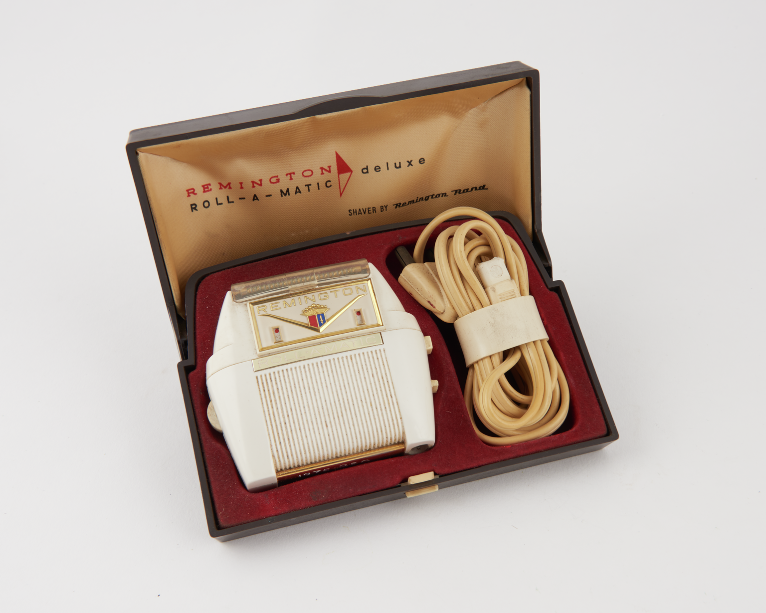 Remington roll-a-matic electric razor and its case. 