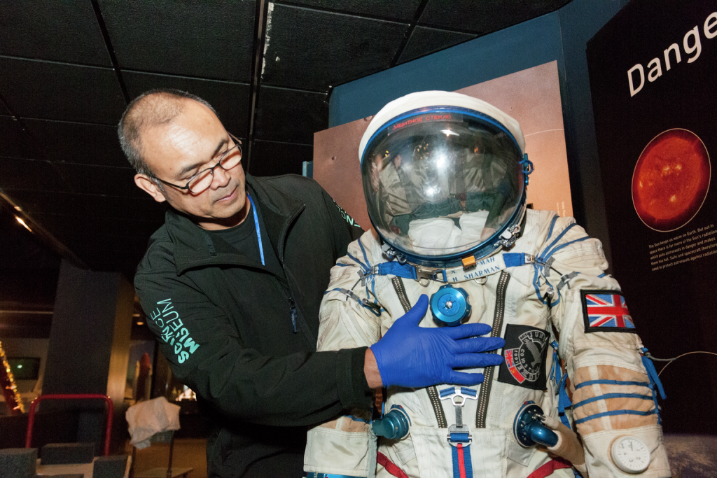 Conservation assistants, installing Helen Sharman's spacesuit which is being re-displayed in the Exploring Space gallery
