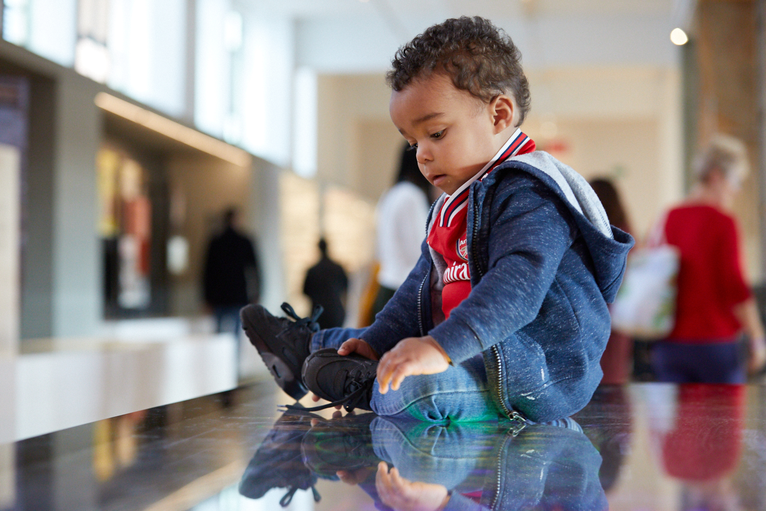 Small child sitting on the interactive game in the Medicine galleries