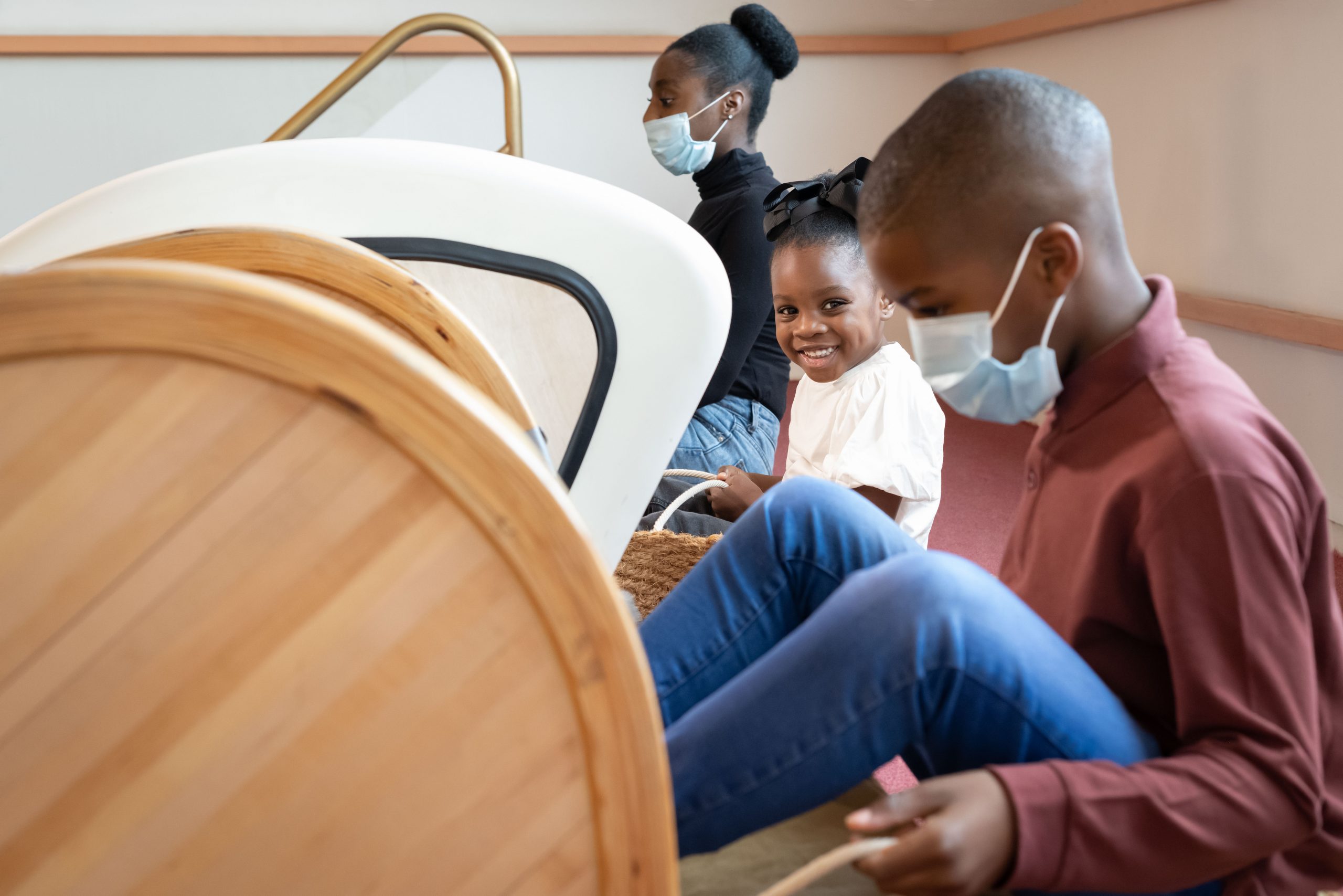 A family at the top of the friction slides within Wonderlab: The Equinor Gallery