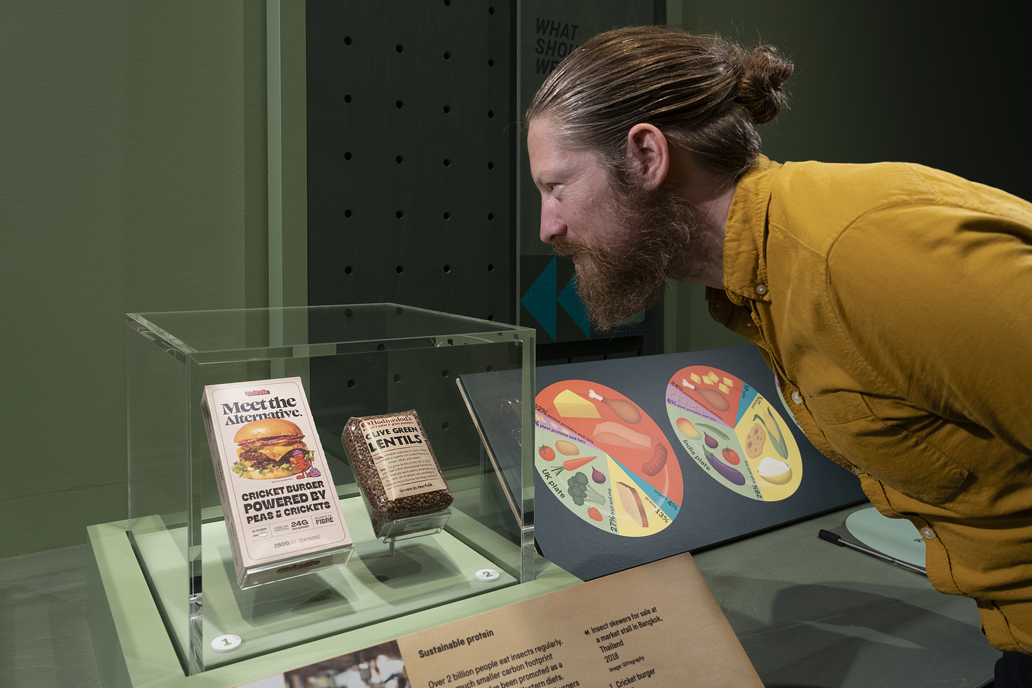 Visitor looking at a cricket burger packaging in Future of Food